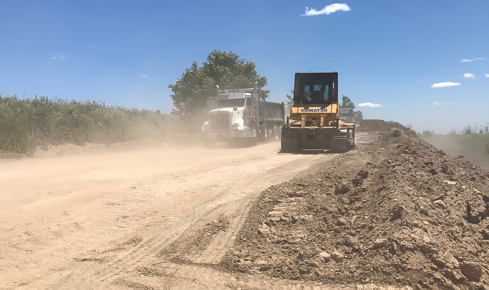 An Ashgrove clean fill site being managed with an excavator and dump truck.